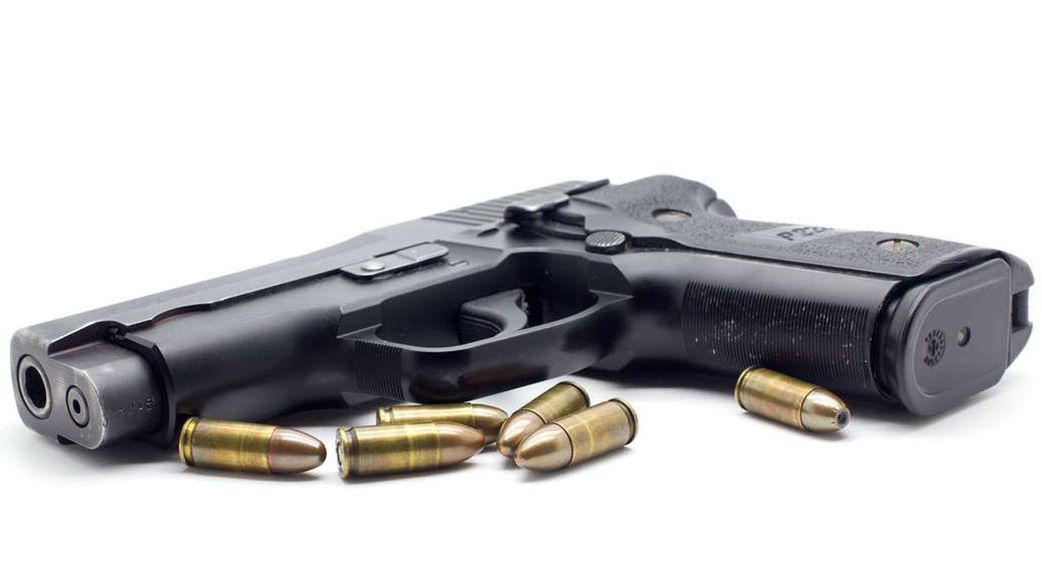 A gun with bullets beside it