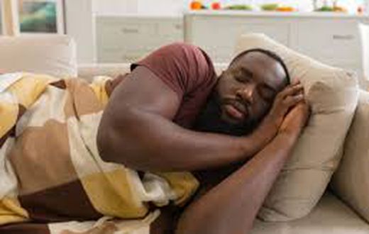 A man taking a nap on the couch
