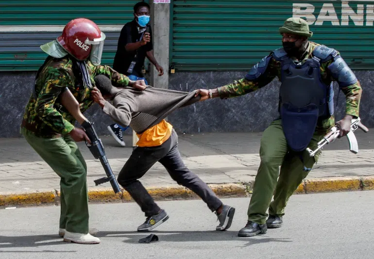 Police manhandling a protestor during protests