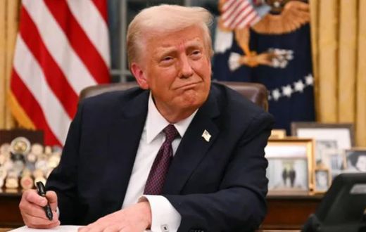 President Donald Trump signs an executive