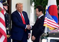 The bruised right hand of U.S. President Donald Trump is visible during a meeting with South Korean President Lee Jae Myung