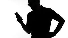 A silhouette of a man  on phone