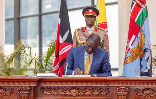 President William Ruto signing a document at State House, Nairobi