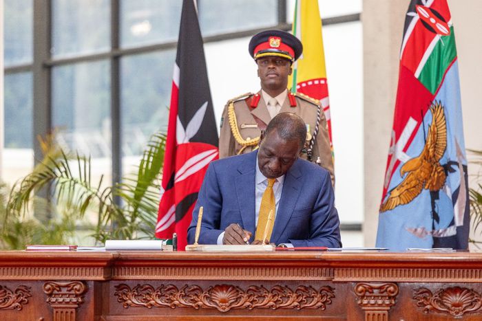 President William Ruto signing a document at State House, Nairobi