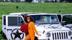 Actress Jackie Vike poses with her Jeep Wrangler