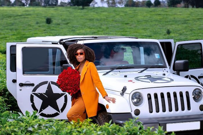 Actress Jackie Vike poses with her Jeep Wrangler