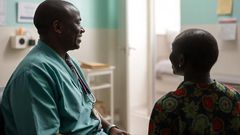 An AI generated image of a doctor smiling while talking to a patient in a hospital