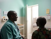 An AI generated image of a doctor smiling while talking to a patient in a hospital