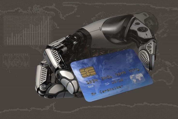A robotic arm holding a debit card