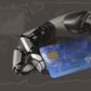 A robotic arm holding a debit card