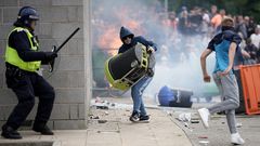 Riot police clash with anti-migration protesters outside of the Holiday Inn Express in Manvers, which is being used as an asylum hotel, on August 4, 2024 in Rotherham, United Kingdom