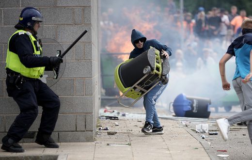Riot police clash with anti-migration protesters outside of the Holiday Inn Express in Manvers, which is being used as an asylum hotel, on August 4, 2024 in Rotherham, United Kingdom