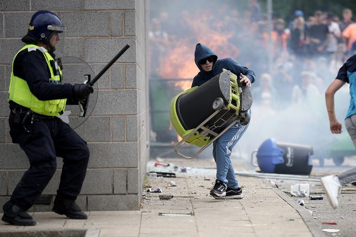 Riot police clash with anti-migration protesters outside of the Holiday Inn Express in Manvers, which is being used as an asylum hotel, on August 4, 2024 in Rotherham, United Kingdom