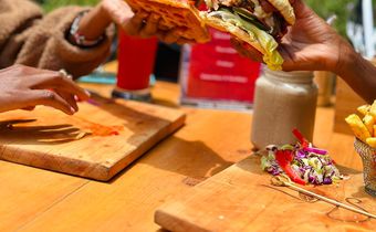Two people enjoying burgers