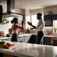 A landscape image of a black man hitting a woman in a modern kitchen