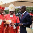 William Ruto receives a donation from John Cardinal Njue (left) during a fundraiser at St Thomas Moore Kairuri Catholic Parish on July 1, 2018