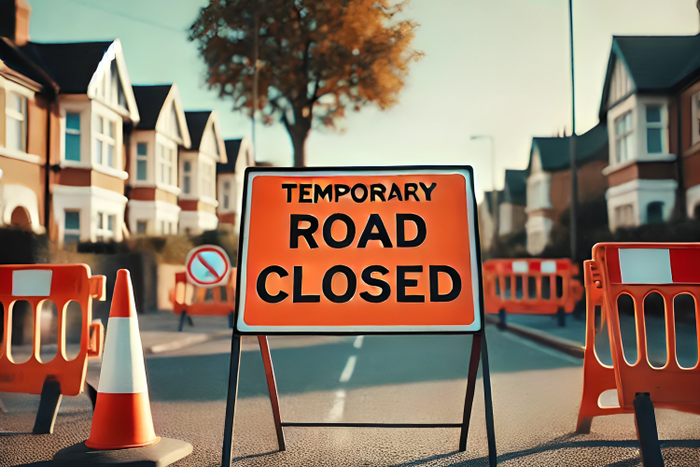 A road closed sign on a suburban street