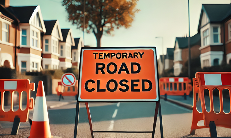 A road closed sign on a suburban street