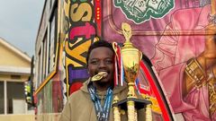 George Ruto poses next to one of his matatus