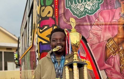 George Ruto poses next to one of his matatus