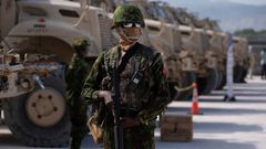 A Kenyan police officer stands next to a row of anti-mine armoured vehicles as the United States Ambassador to the United Nations Linda Thomas-Greenfield toured the Multinational Security Support (MSS) mission in Haiti base near the airport in Port-au-...