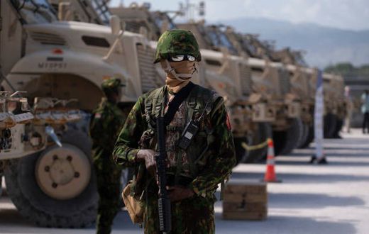 A Kenyan police officer stands next to a row of anti-mine armoured vehicles as the United States Ambassador to the United Nations Linda Thomas-Greenfield toured the Multinational Security Support (MSS) mission in Haiti base near the airport in Port-au-...