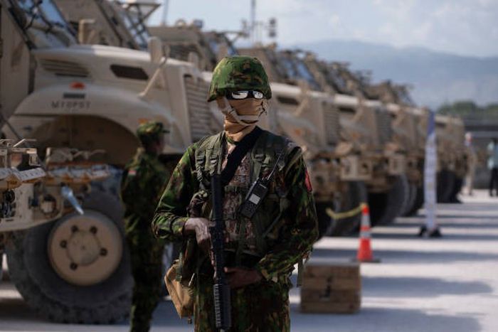 A Kenyan police officer stands next to a row of anti-mine armoured vehicles as the United States Ambassador to the United Nations Linda Thomas-Greenfield toured the Multinational Security Support (MSS) mission in Haiti base near the airport in Port-au-...