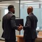 An AI generated image showing two black men exchanging a briefcase in an office