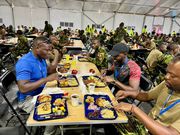 Larry Madowo having lunch with Kenyan police in Haiti
