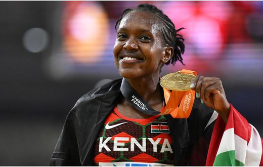 Faith Kipyegon shows off her Gold Medal during a past competition