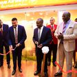 The PS Transport Mohammed Daghar cuts a ribbon to launch a KQ ticketing office at KICC. Looking on is KICC CEO James Mwaura, Principle Administrative secretary Public service Authur Osiya, KQ CEO Allan Kivaluka