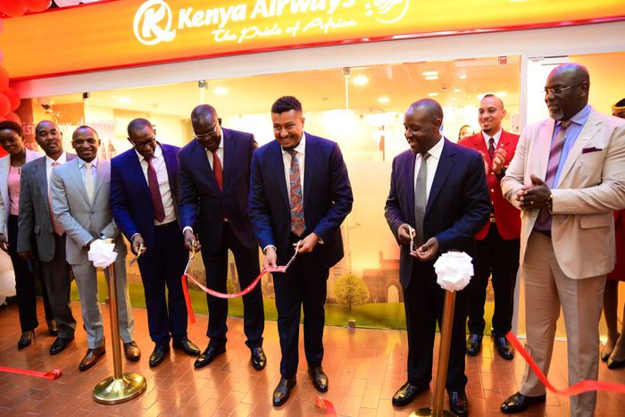 The PS Transport Mohammed Daghar cuts a ribbon to launch a KQ ticketing office at KICC. Looking on is KICC CEO James Mwaura, Principle Administrative secretary Public service Authur Osiya, KQ CEO Allan Kivaluka