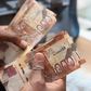 A person holding Kenyan currency