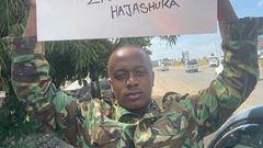 Jackson Kuria, also known as Cop Shakur, holds a placard rejecting the proposed Finance Bill during the June 25, 2024, protests.
