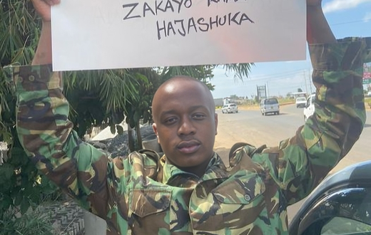 Jackson Kuria, also known as Cop Shakur, holds a placard rejecting the proposed Finance Bill during the June 25, 2024, protests.