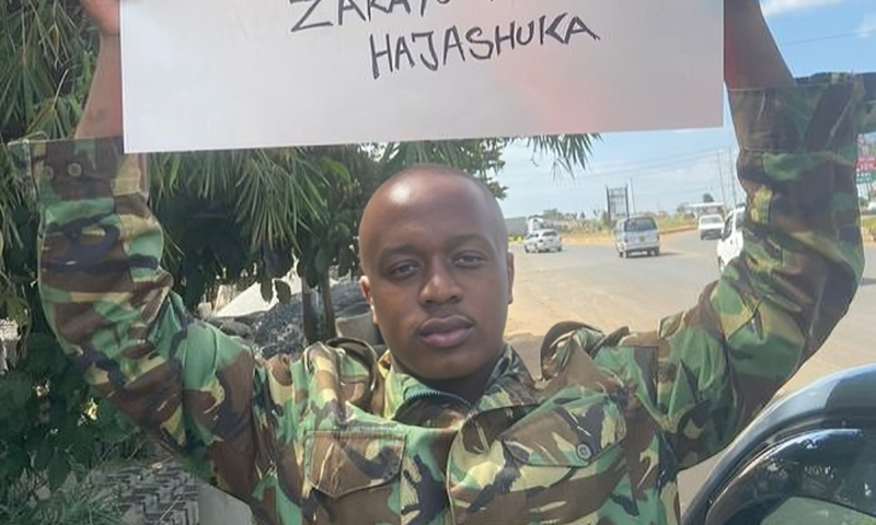 Jackson Kuria, also known as Cop Shakur, holds a placard rejecting the proposed Finance Bill during the June 25, 2024, protests.