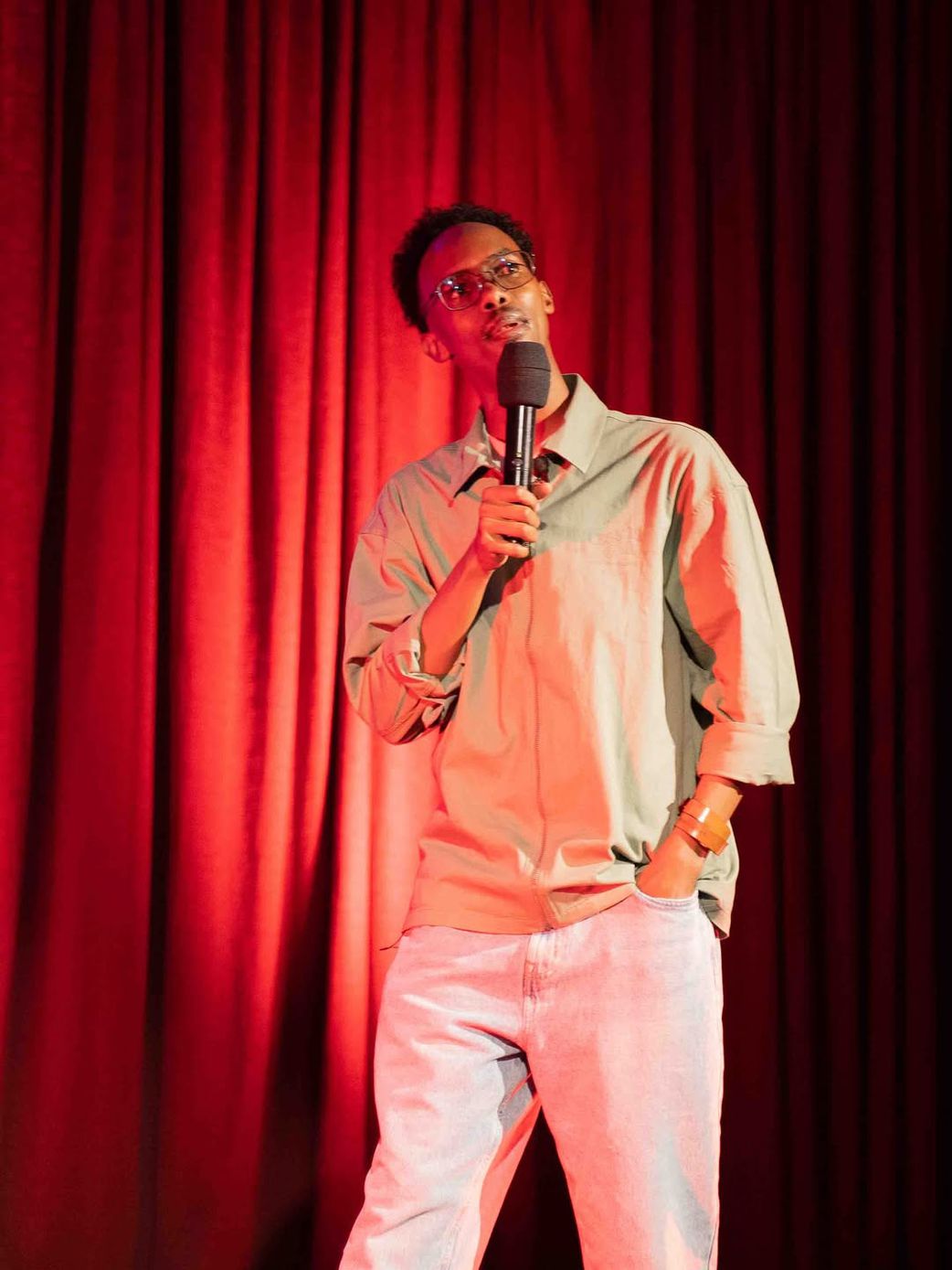 Comedian Adan Abdi on stage at his June 2025 Eid comedy showcase "Go Back To Somalia"