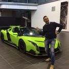 American collector Kris Singh poses alongside his green Lamborghini Veneno Coupé