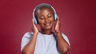A lady listening to music through headphones