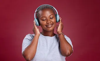 A lady listening to music through headphones