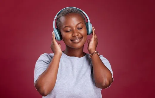 A lady listening to music through headphones