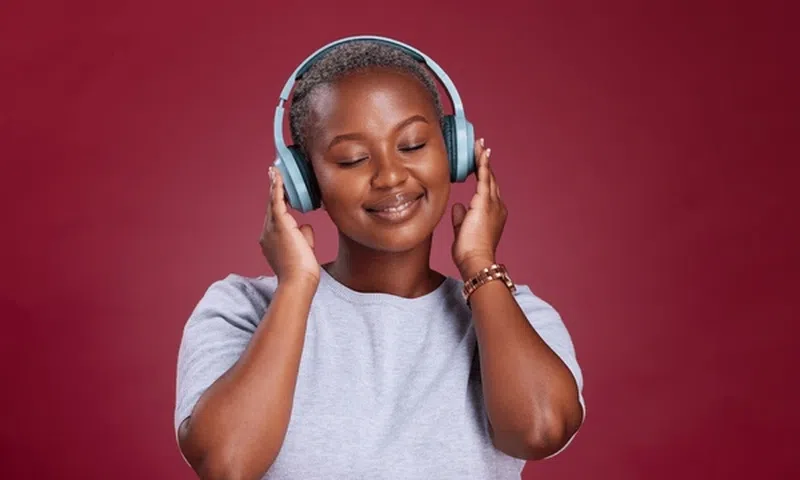 A lady listening to music through headphones