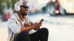 A lady listening to music through headphones