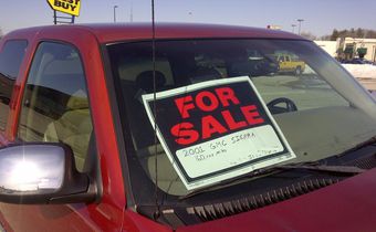 A 'for sale' sign on a car