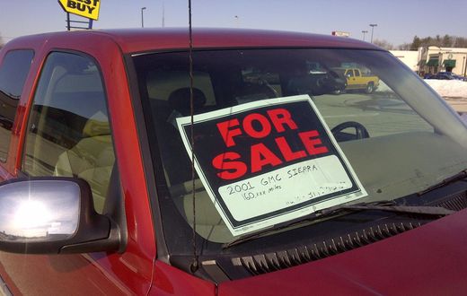 A 'for sale' sign on a car