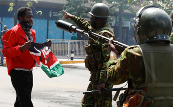 File image of police officers with a peaceful protester in Nairobi