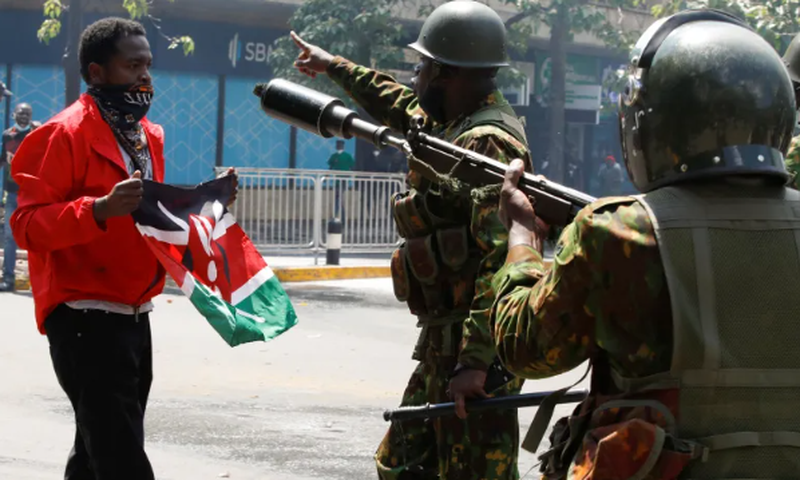 File image of police officers with a peaceful protester in Nairobi