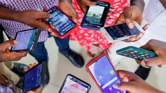 A group of people using mobile phones