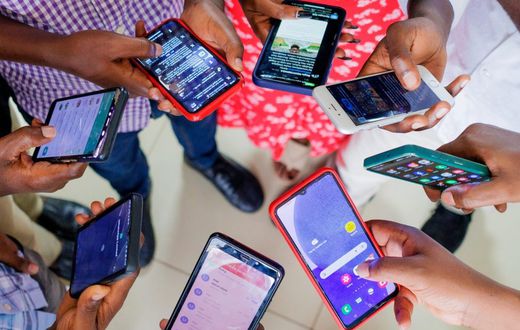 A group of people using mobile phones