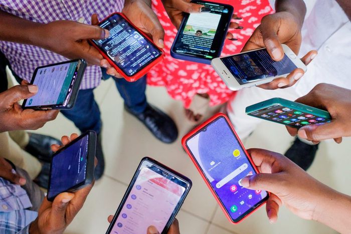 A group of people using mobile phones